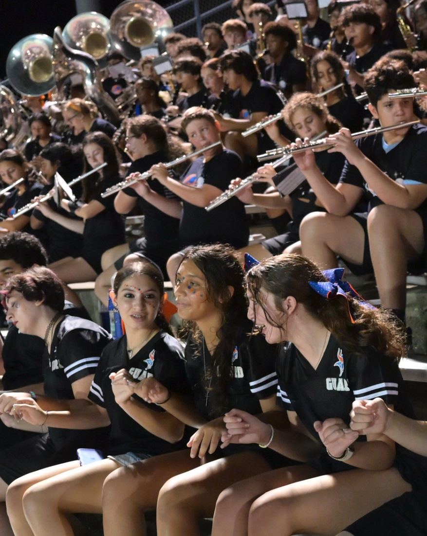 West Orange band and color guard students performing in the stands.